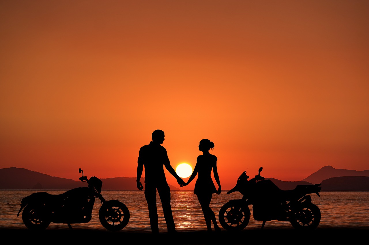 sunset bikes  couple  oceans free photo