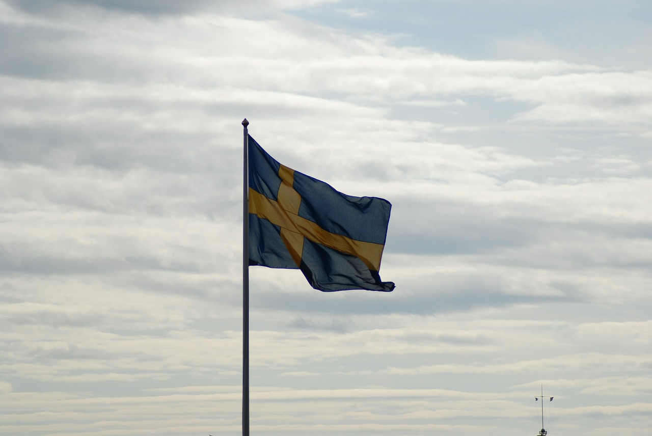 swedish flag cloudy sky summer free photo