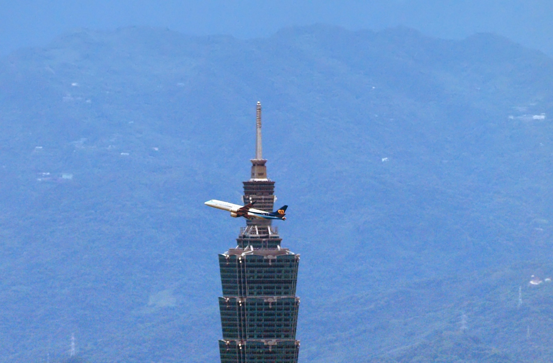 taipei 101 taipei domestic airport taipei 101 with plane crossing top free photo