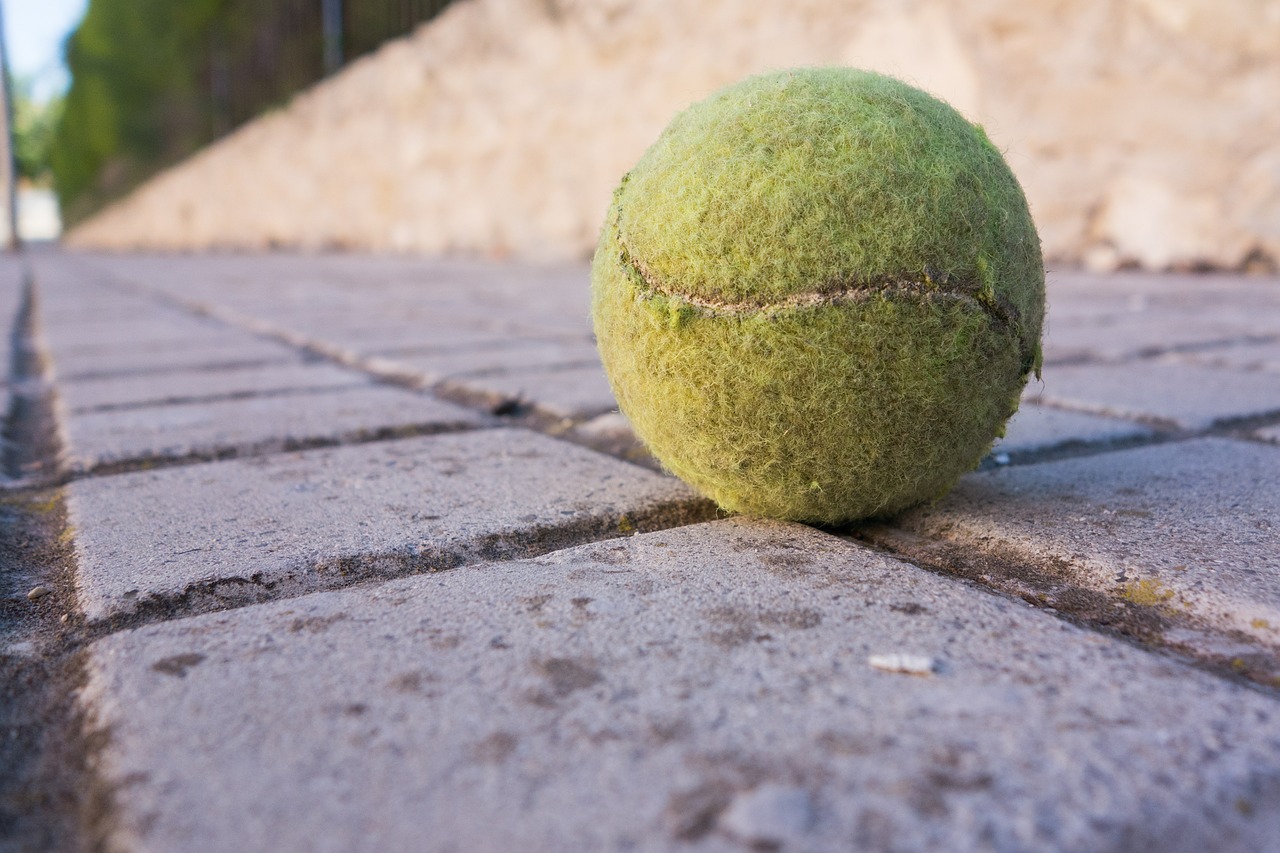 tennis ball sidewalk soil free photo