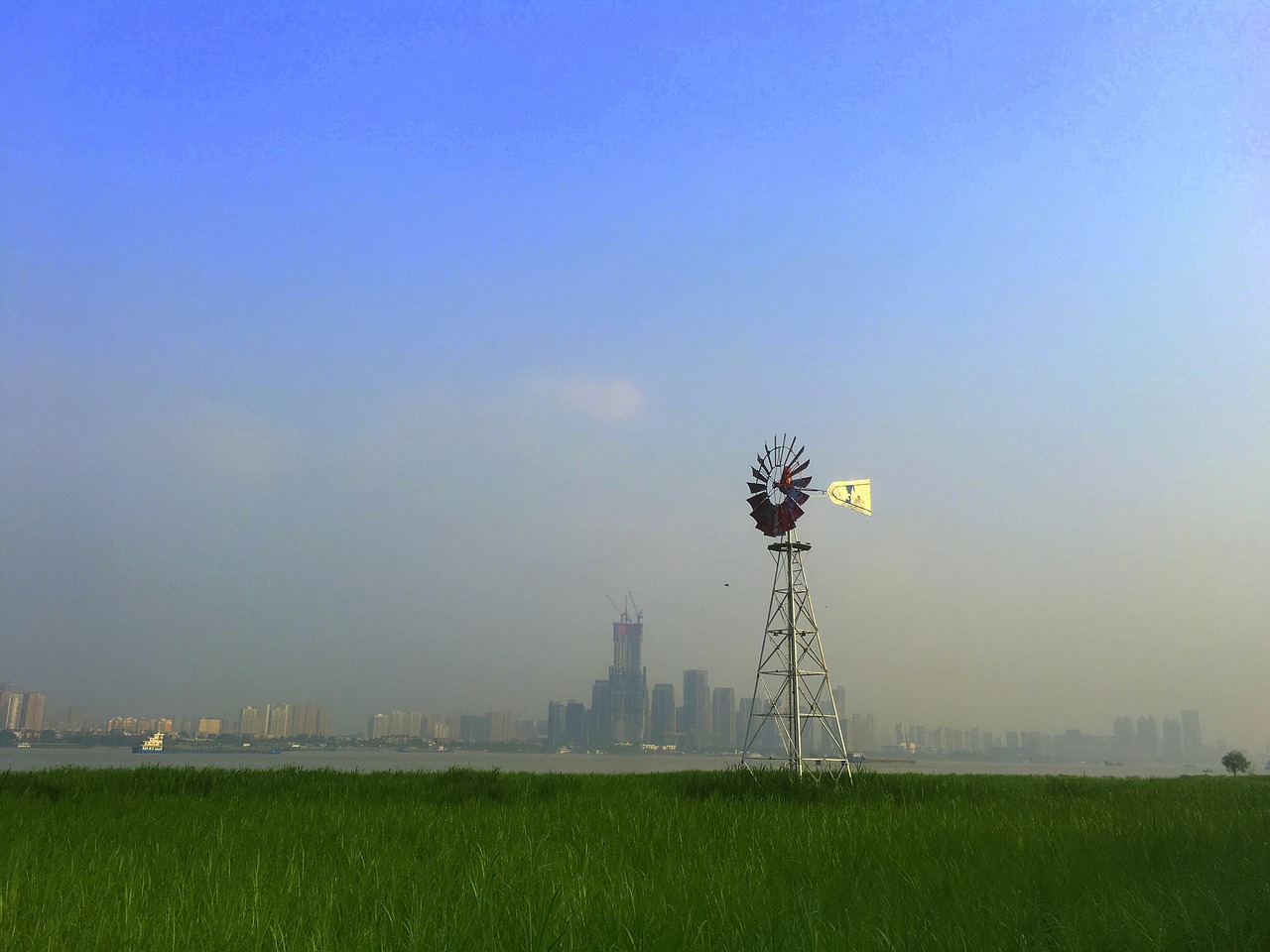 the great river windmill on the opposite bank free photo