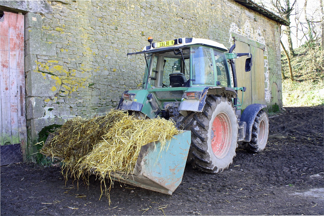 tractor with straw farmyard straw tractor in yard free photo