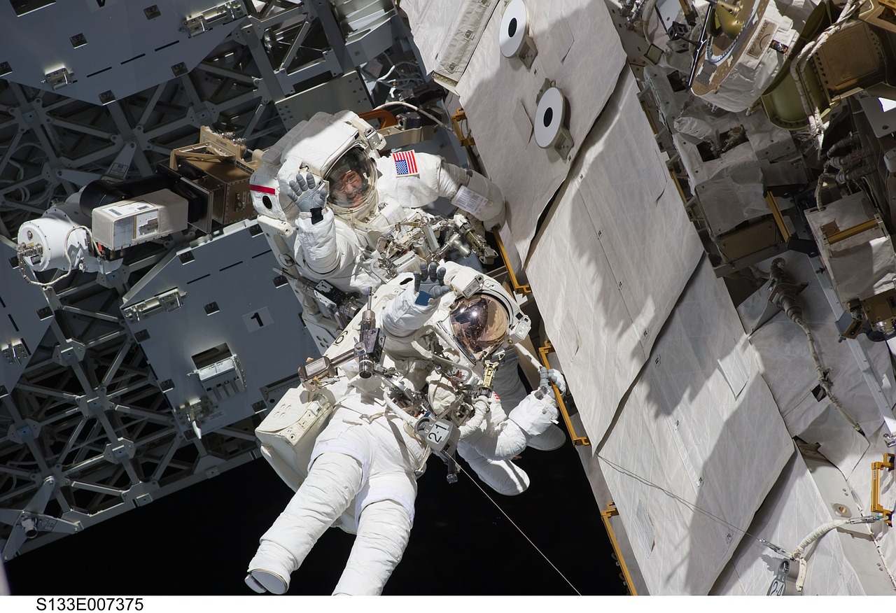 two astronauts spacewalk space shuttle free photo