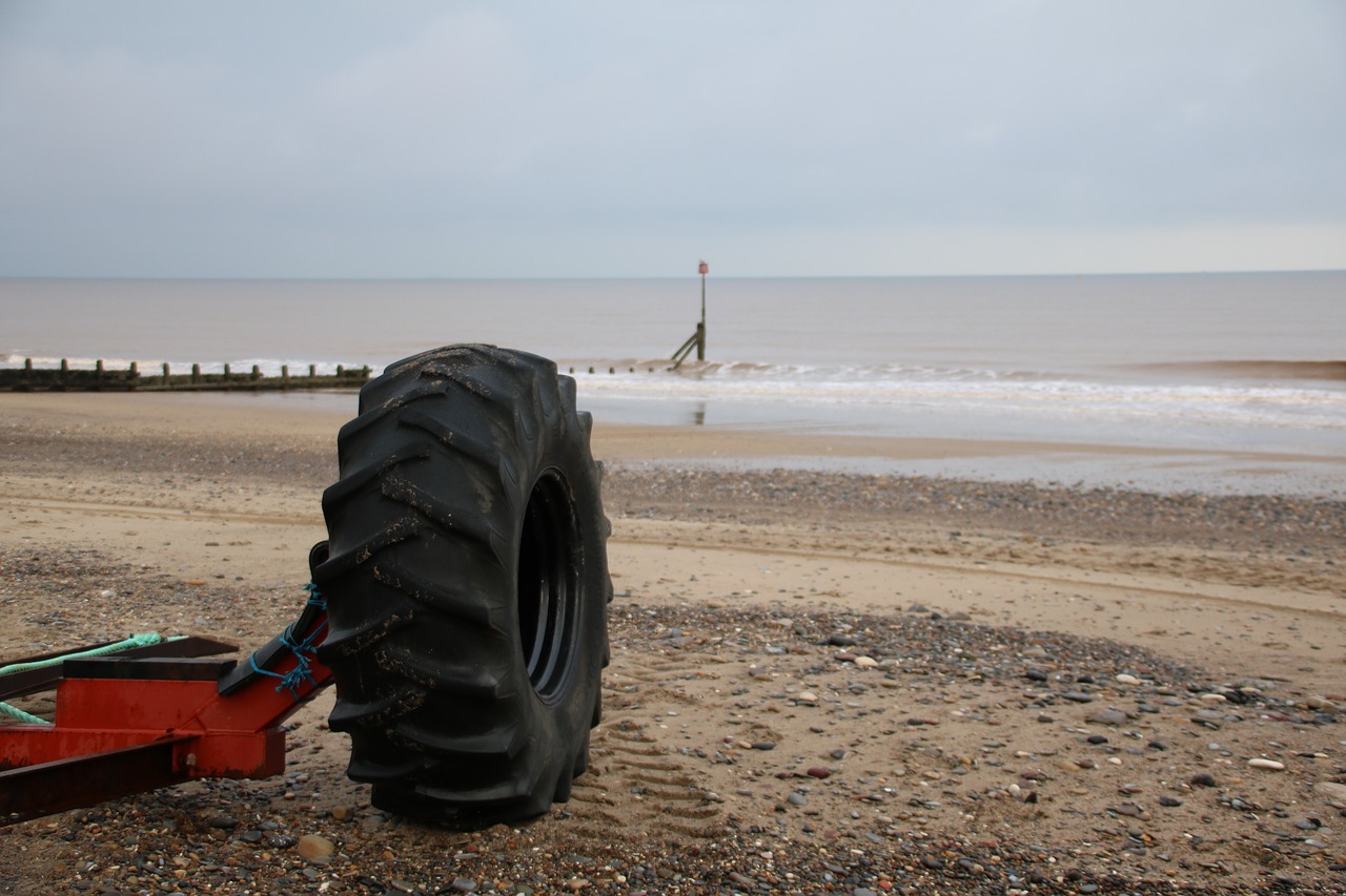tyre on beach seaside beach free photo