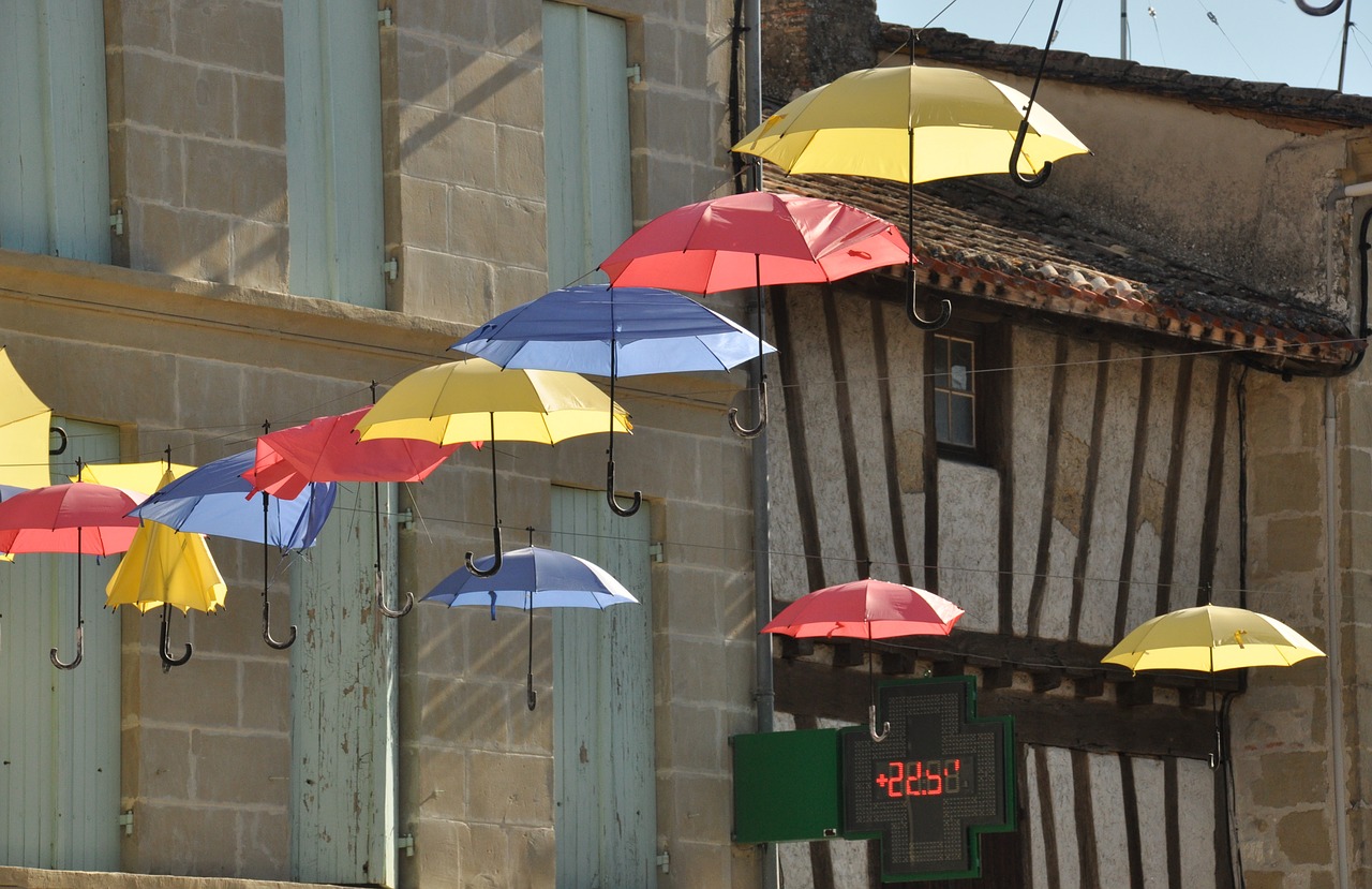 umbrellas  village street  sun free photo