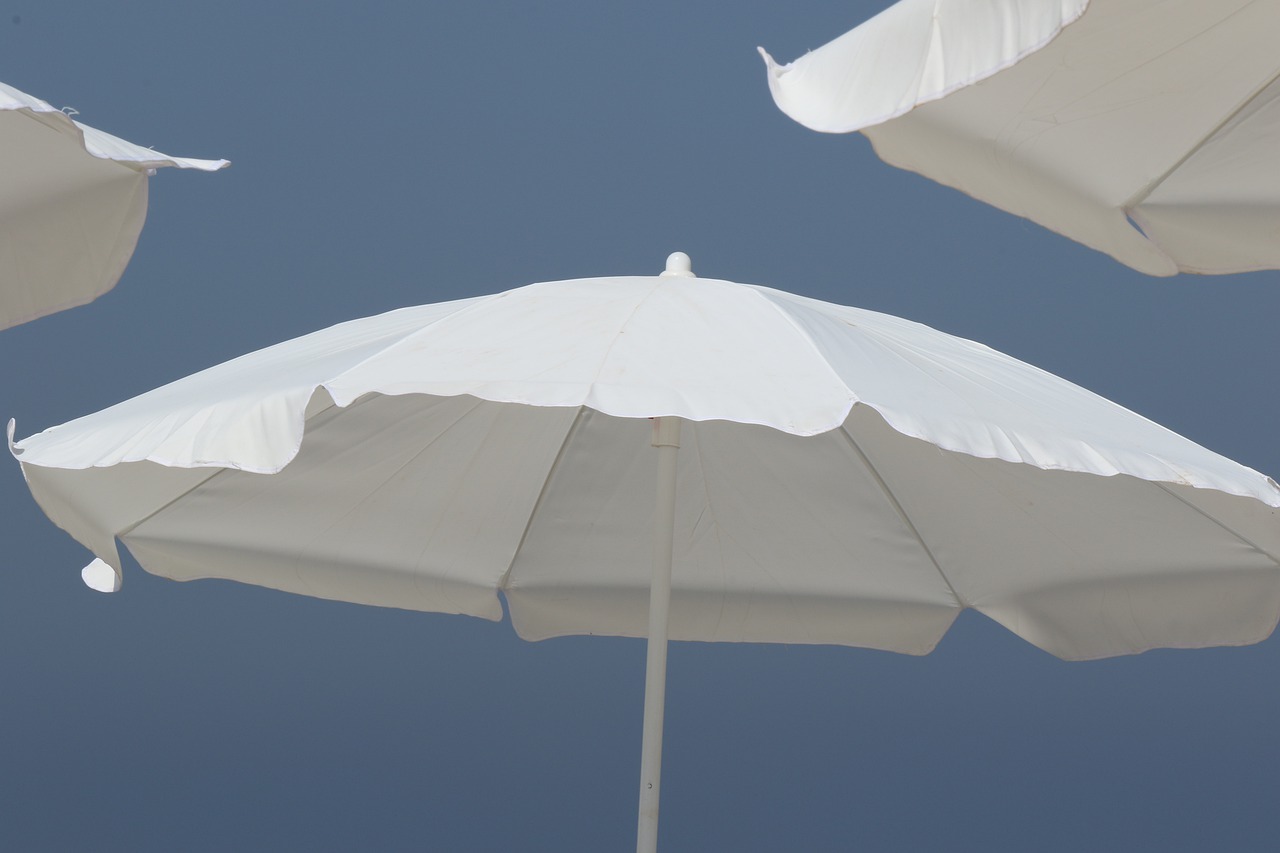 umbrellas  skies  beach free photo