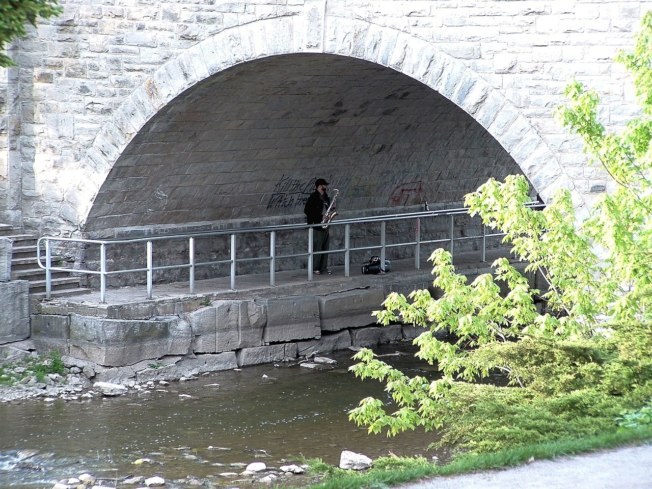 under a bridge river saxophone free photo