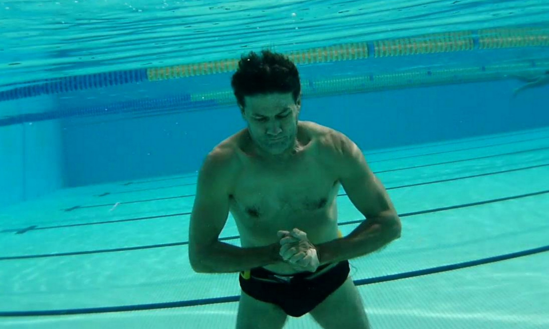 man underwater swimming free photo