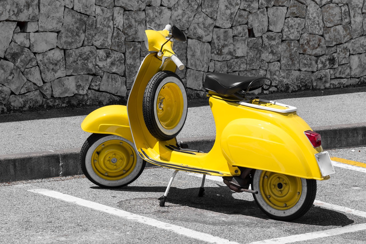 vespa yellow motor scooter free photo