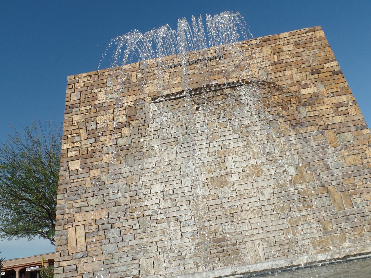 waterfall brick wall blue sky free photo