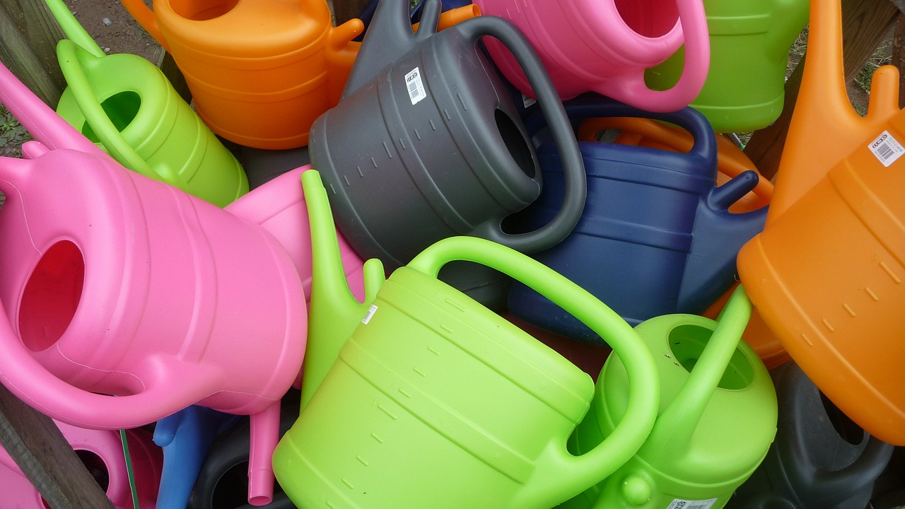 watering cans colorful plastic free photo