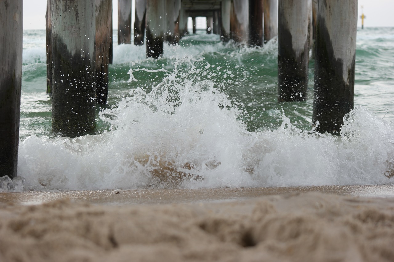 waves breaking waves under a pier beach waves free photo
