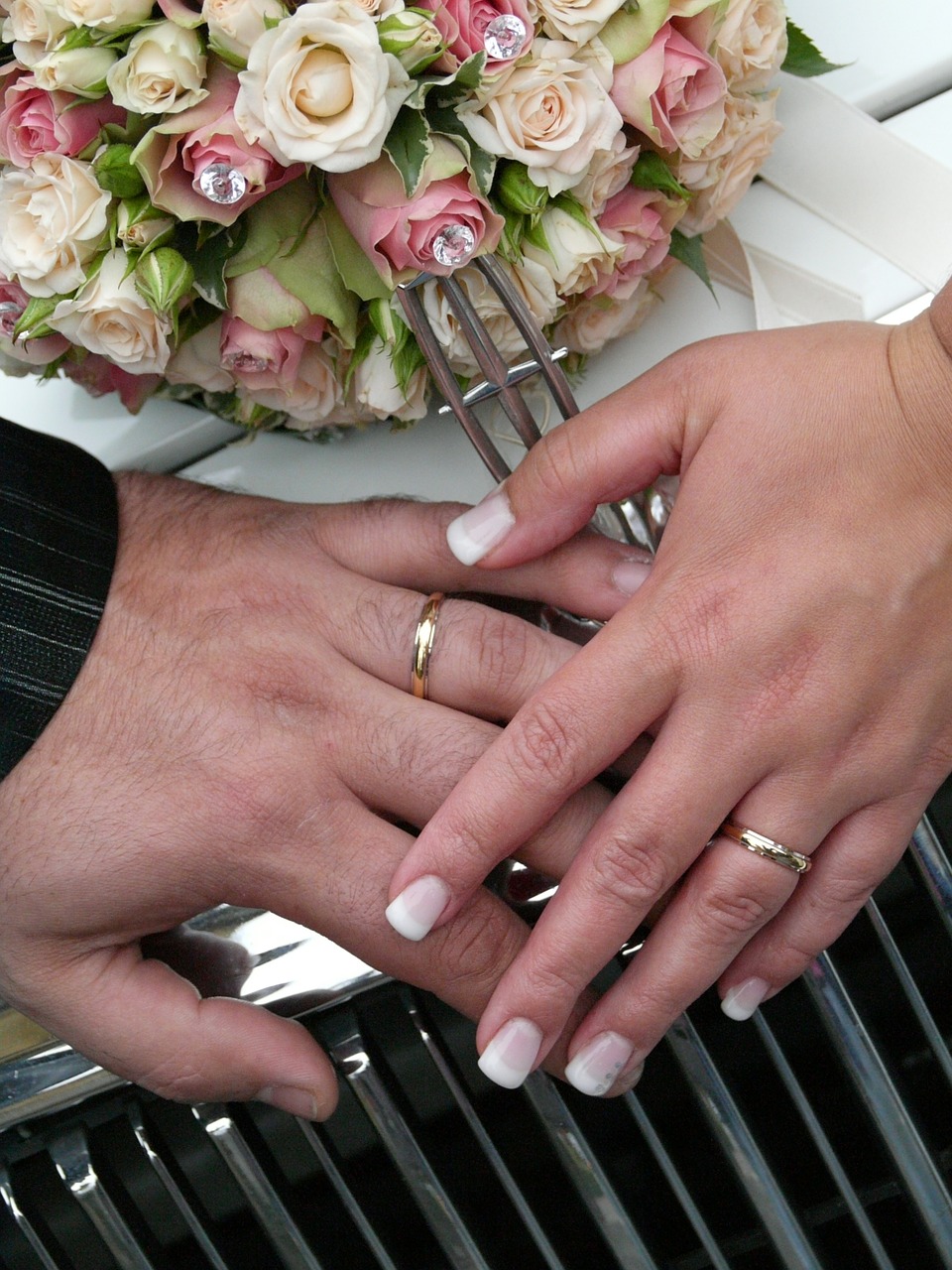 wedding bride and groom hand with wedding bands spouses free photo