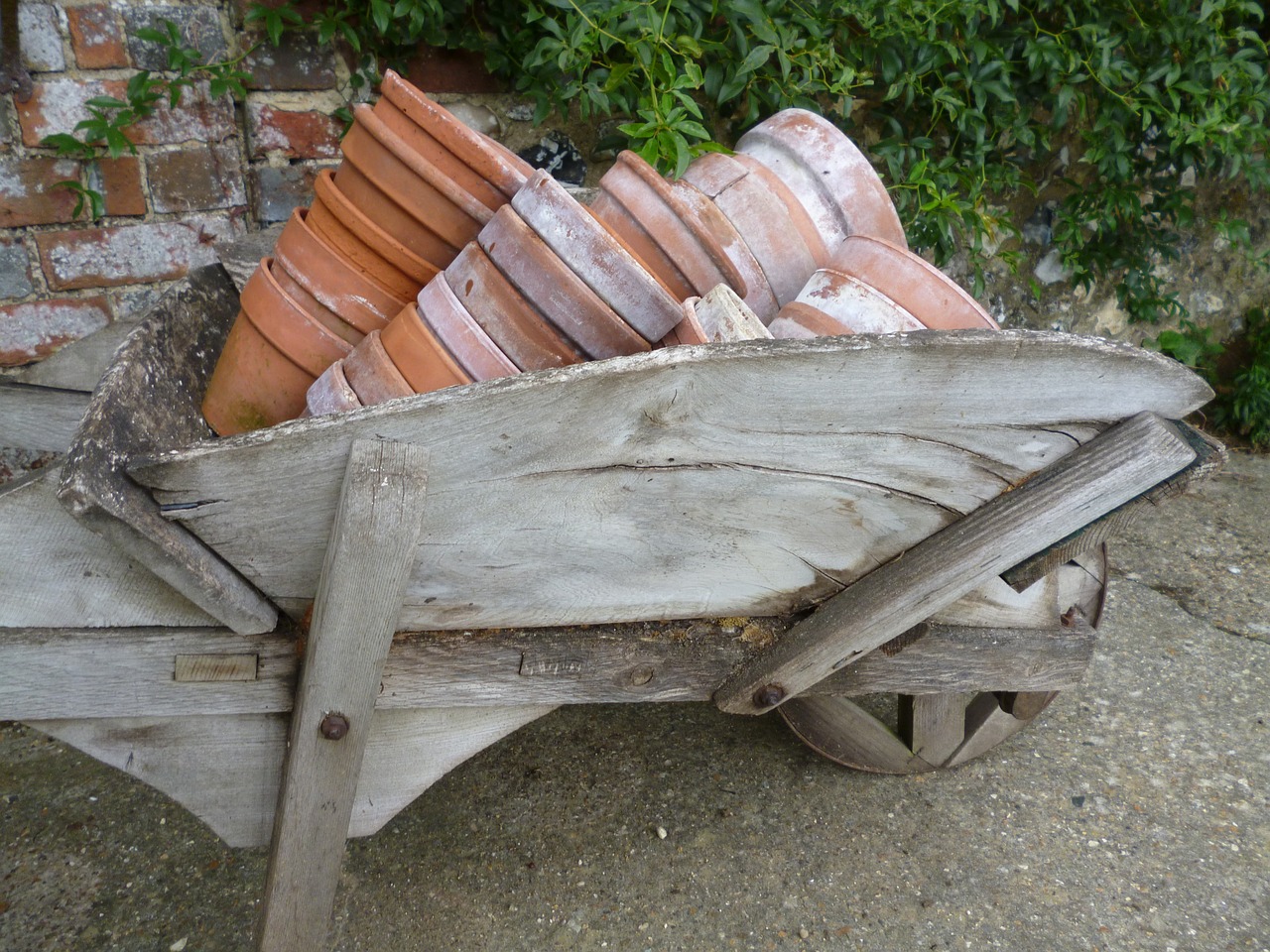 wheelbarrow plant pots gardening free photo