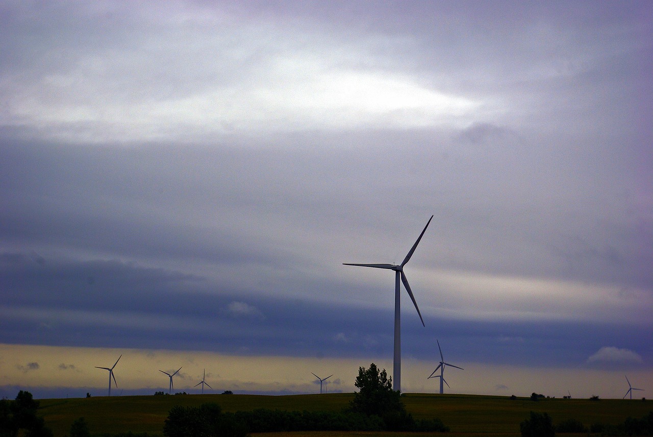 wind turbines against dark clouds  wind  power free photo