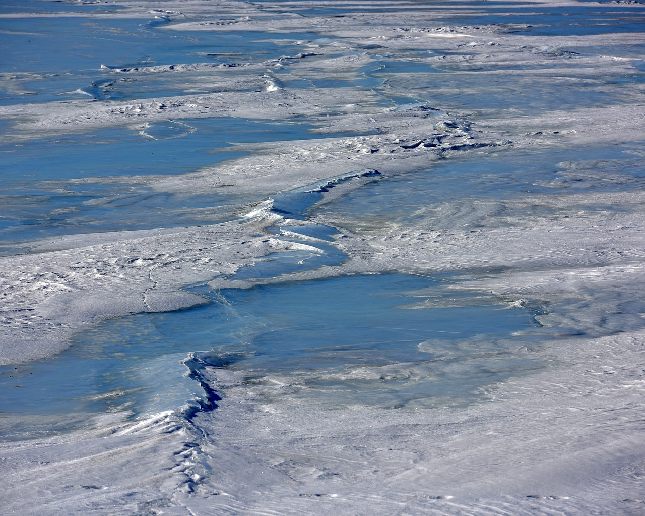 winter  frozen river  ice cracks free photo