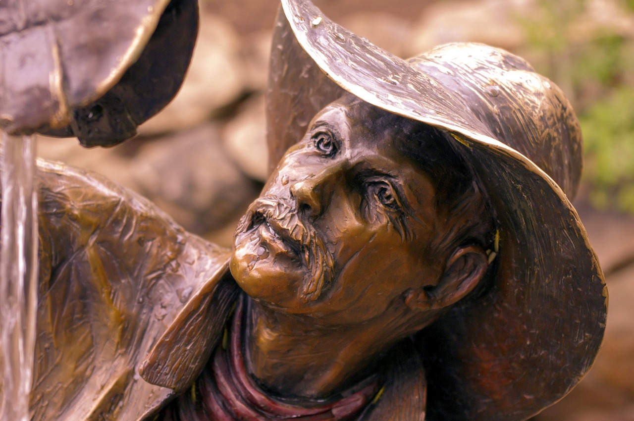wishful thinkin cowboy  sculpture  bronze free photo