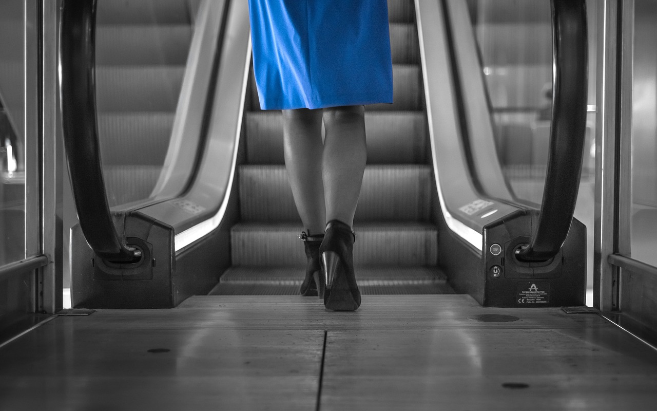 woman blue dress escalator free photo