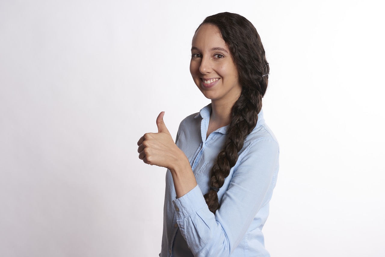 woman thumbs up smiling free photo