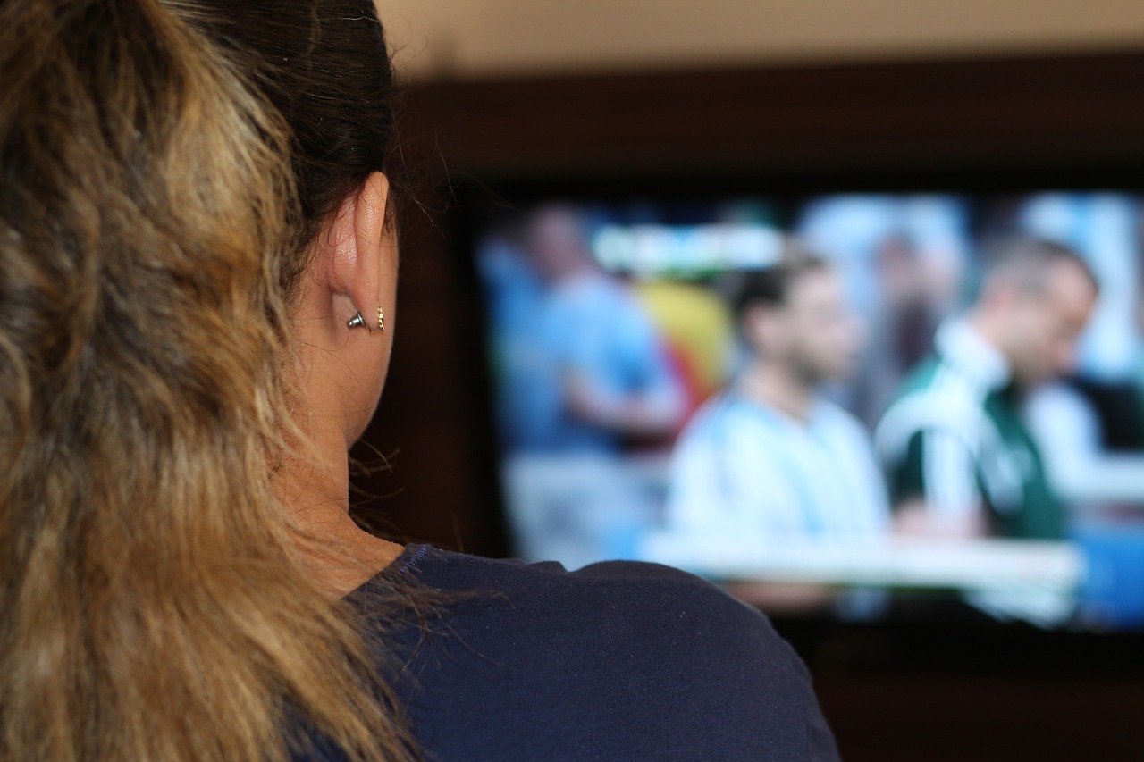 woman watching tv tv free photo