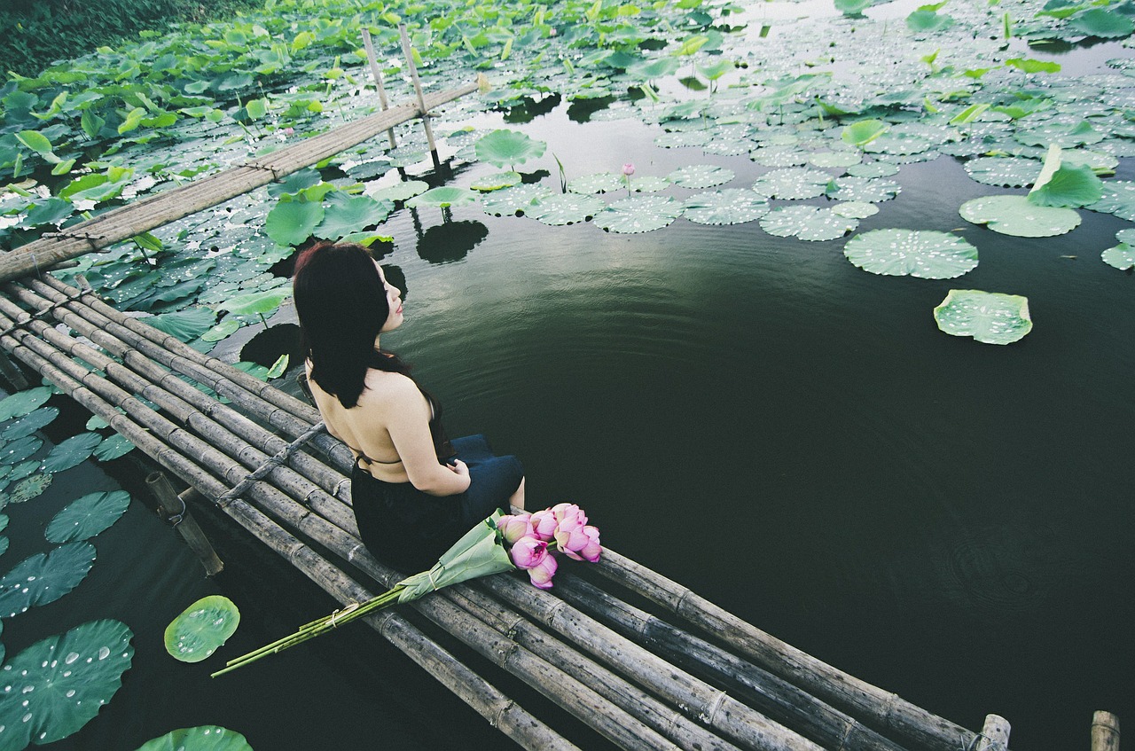 woman sitting pond free photo