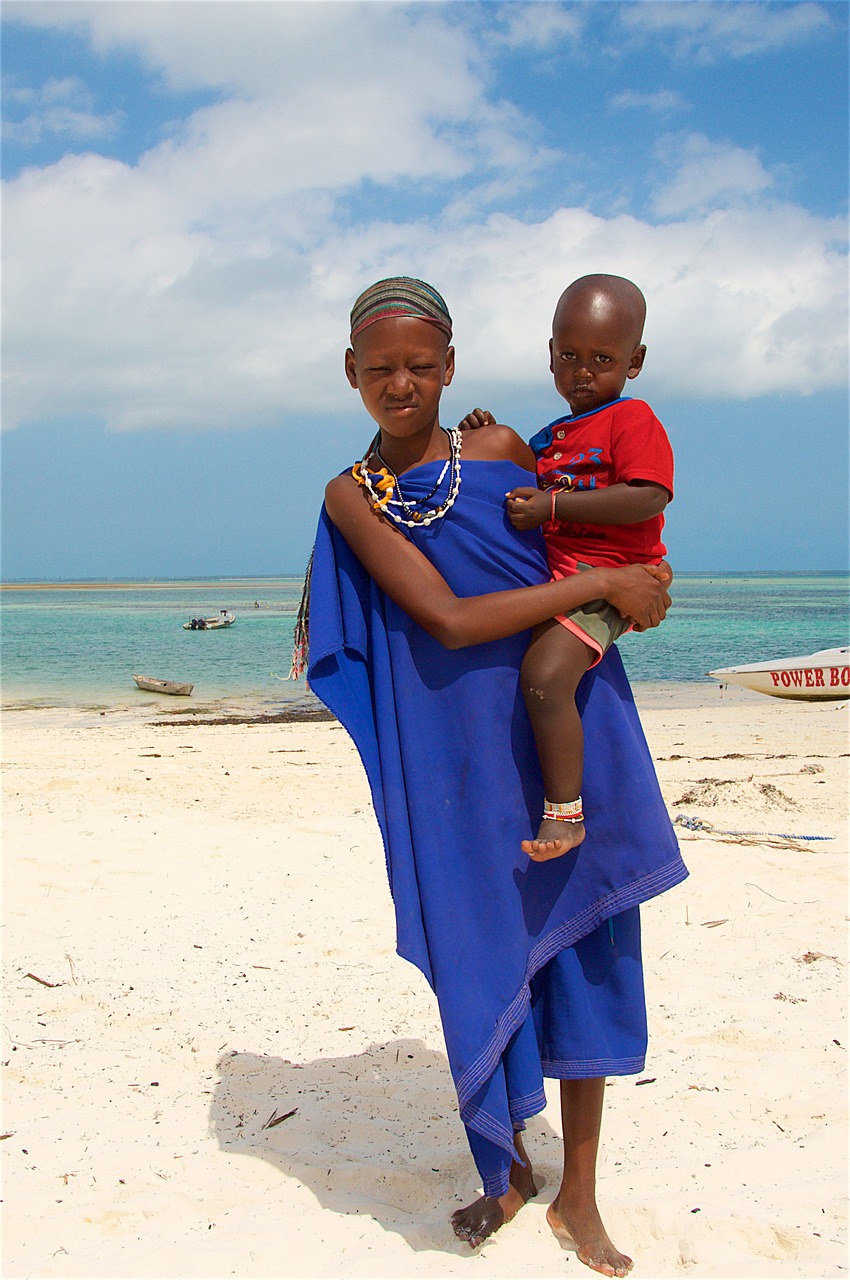 woman with a child beach zanzibar free photo