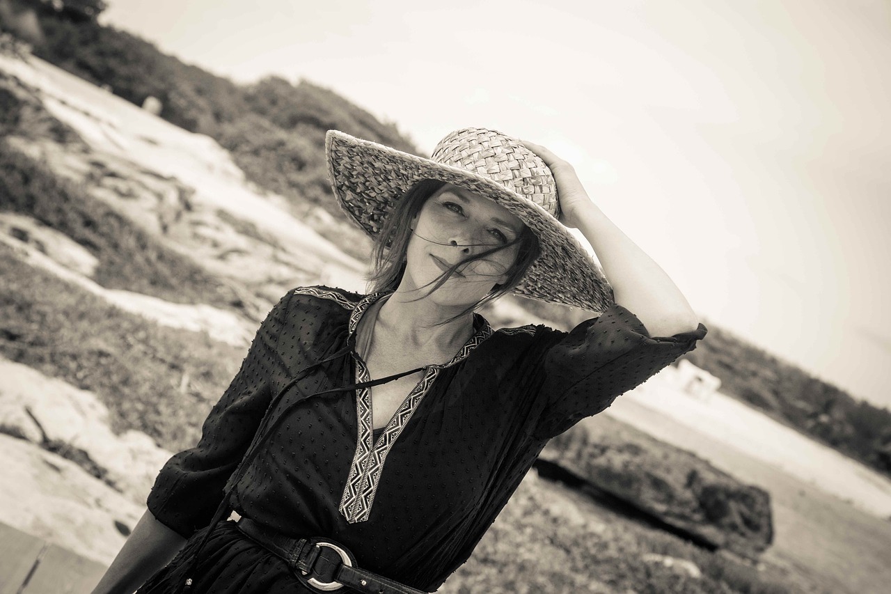 woman with straw hat woman at the beach vacations free photo