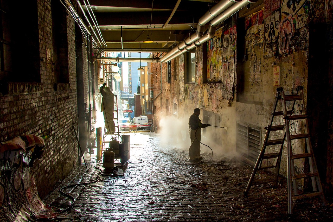 workers cleaning graffiti free photo