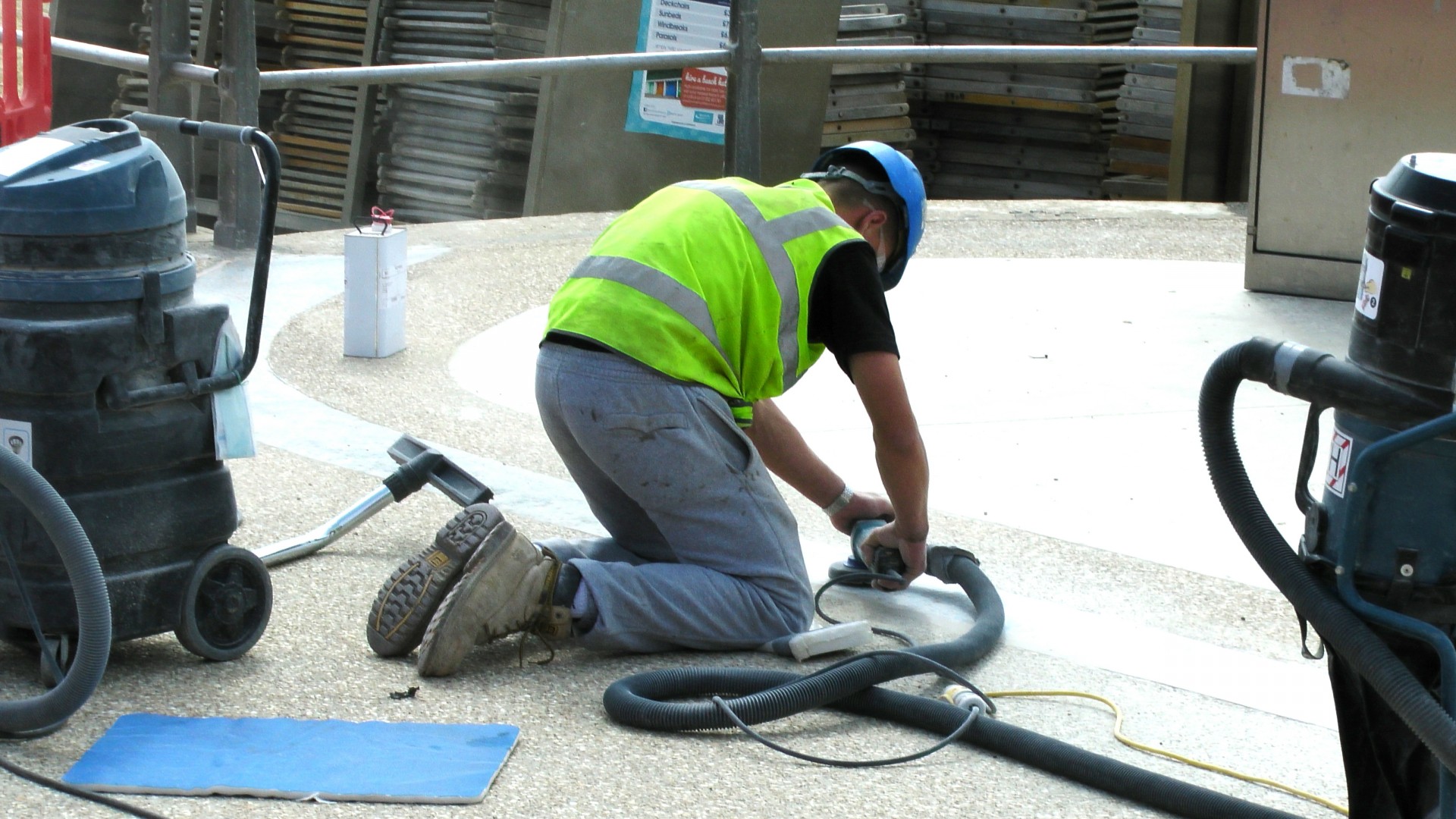 workman grinding cement walkway workman laborer free photo