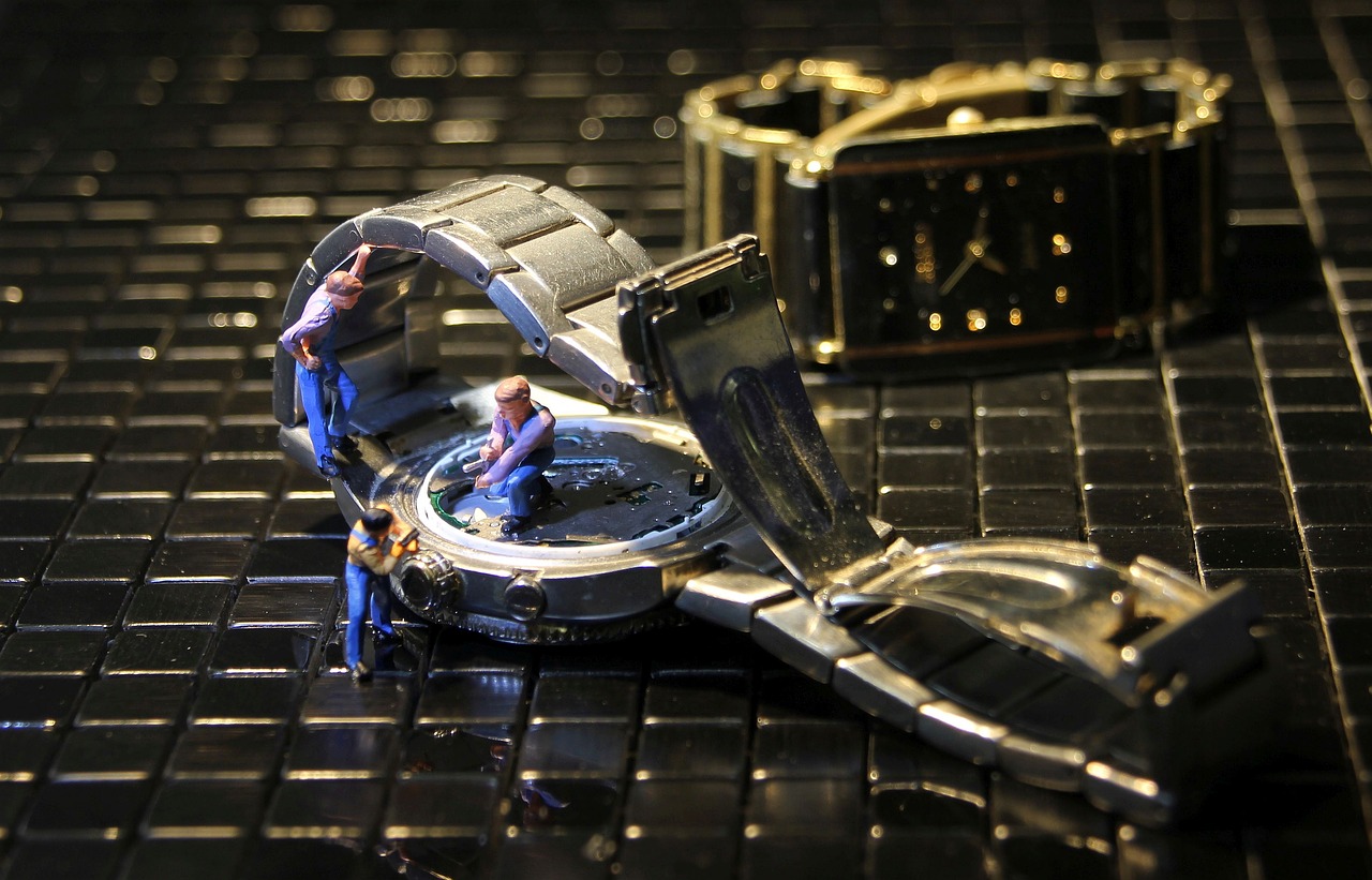 wrist watch  watchmaker  miniature figures free photo