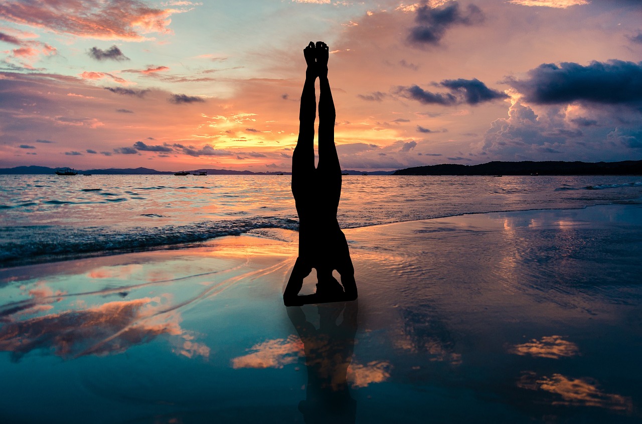 yoga stand in hands silhouette sunset beach zen position by the sea free photo