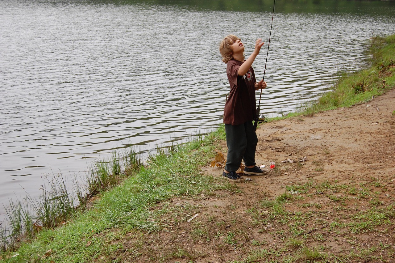 young boy fishing free photo