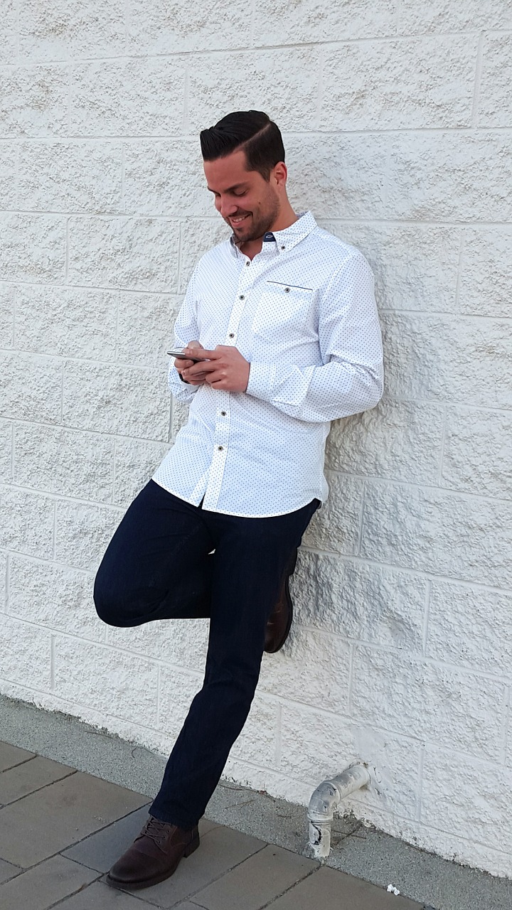 young man standing brick wall free photo