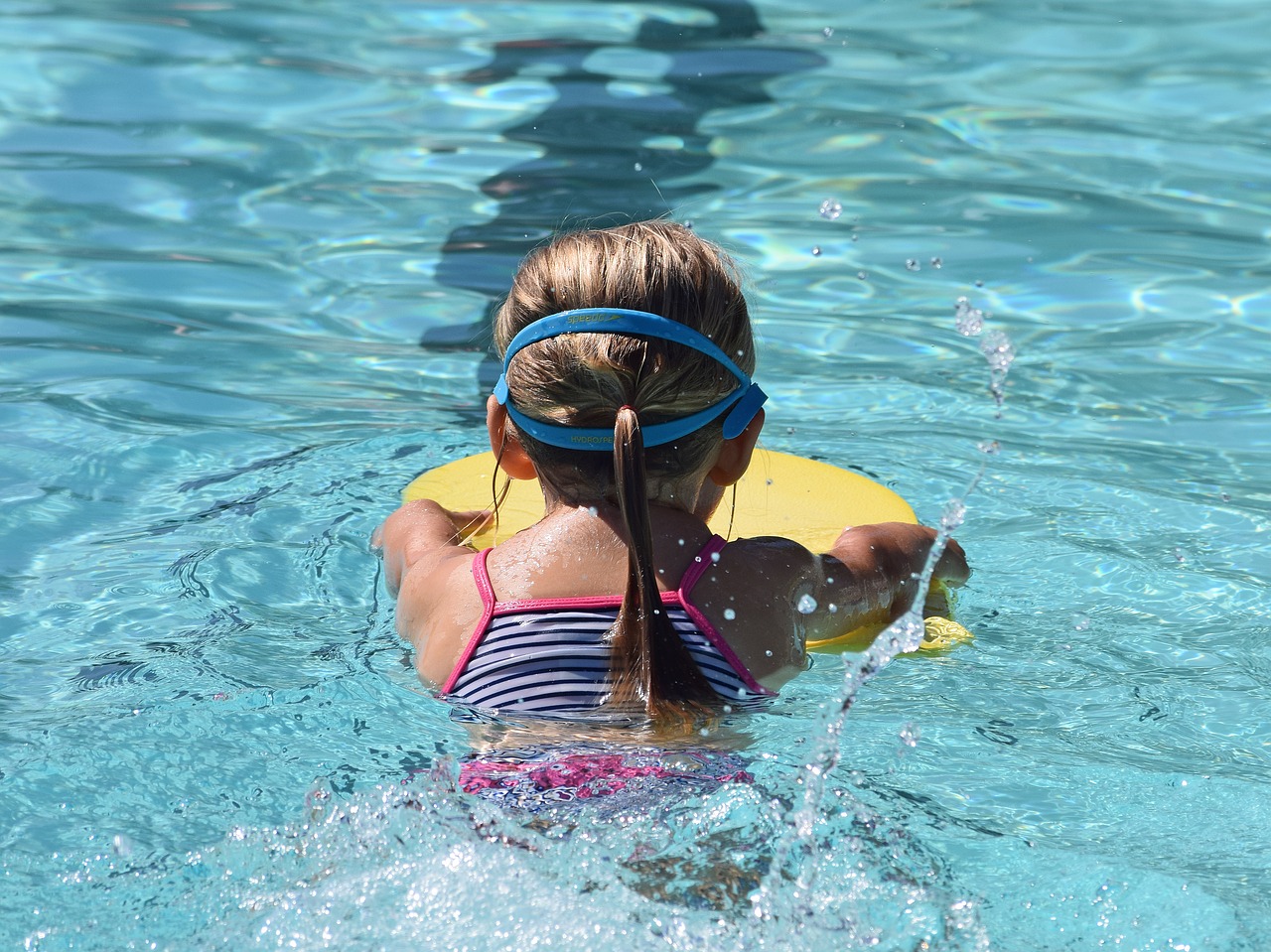 young swimmer child kick board free photo