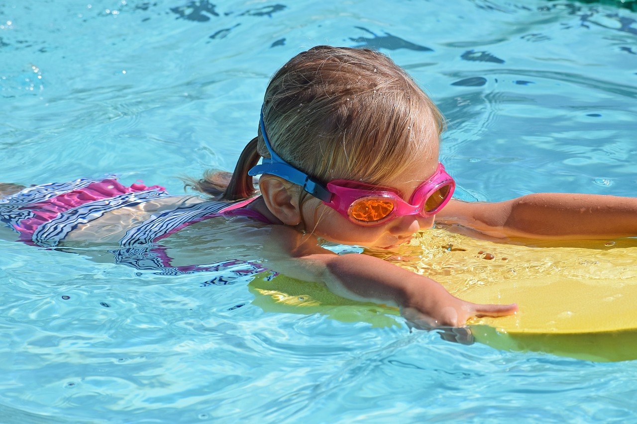 young swimmer child kick board free photo