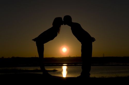a kiss on the a couple of sunset