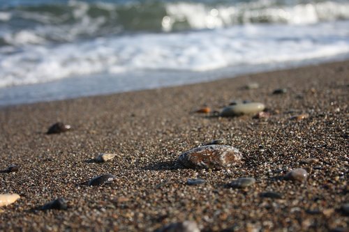 a mr  wave  stone on the beach