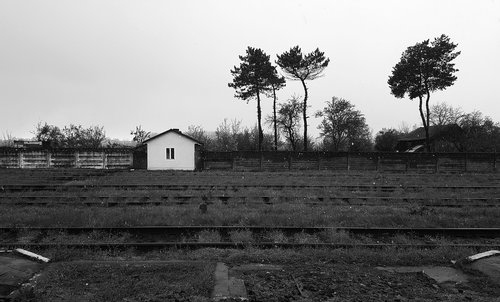 abandoned train station  black and white  railroad