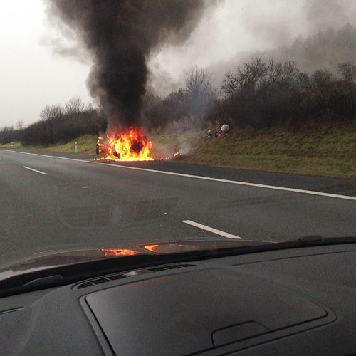 accident highway burning car