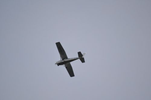 aircraft grey sky small plane