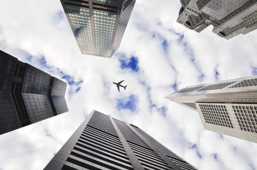 airplane sky buildings