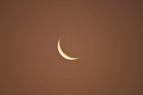 Amber Tinted Sky And Crescent Moon