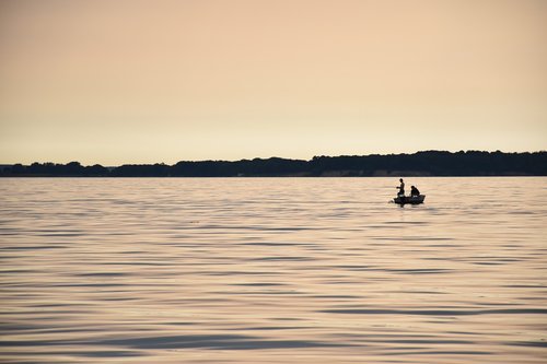 angler  evening sun  sea