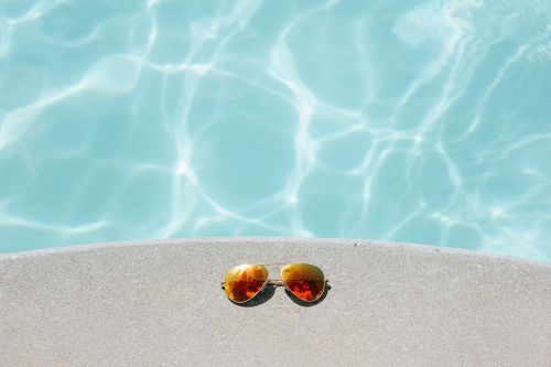 aviator sunglasses concrete surface pool