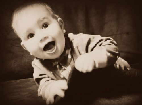 baby sepia laughing