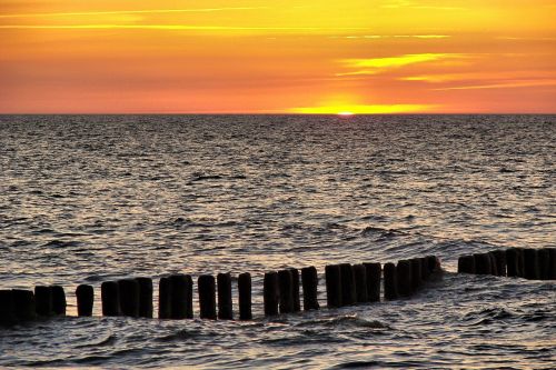 baltic sea breakwater sunset