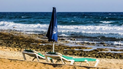 beach rocky coast sun bed