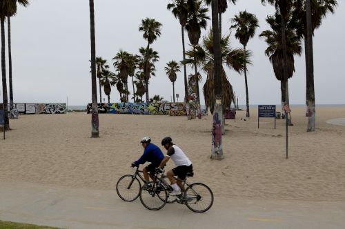 beach cyclists people