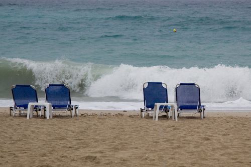 beach sun lounges waves