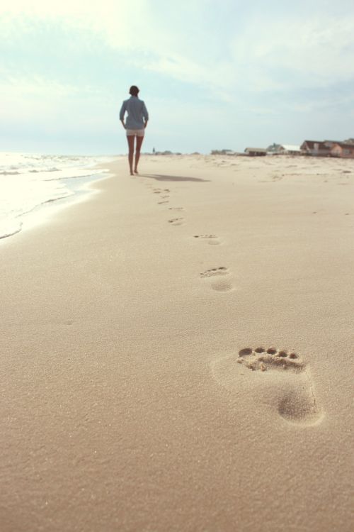 beach woman footprints